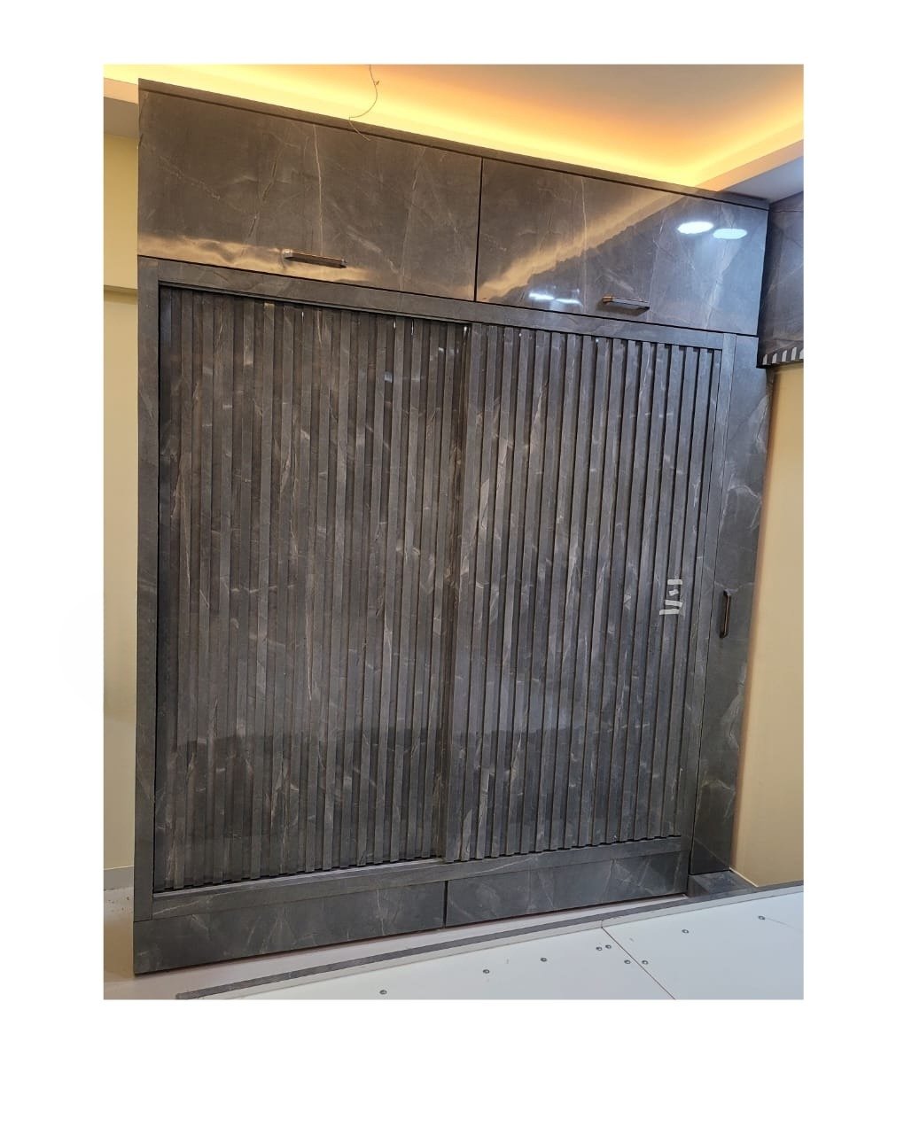 Custom sliding wardrobe with textured finish installed in Jogeshwari West, Mumbai