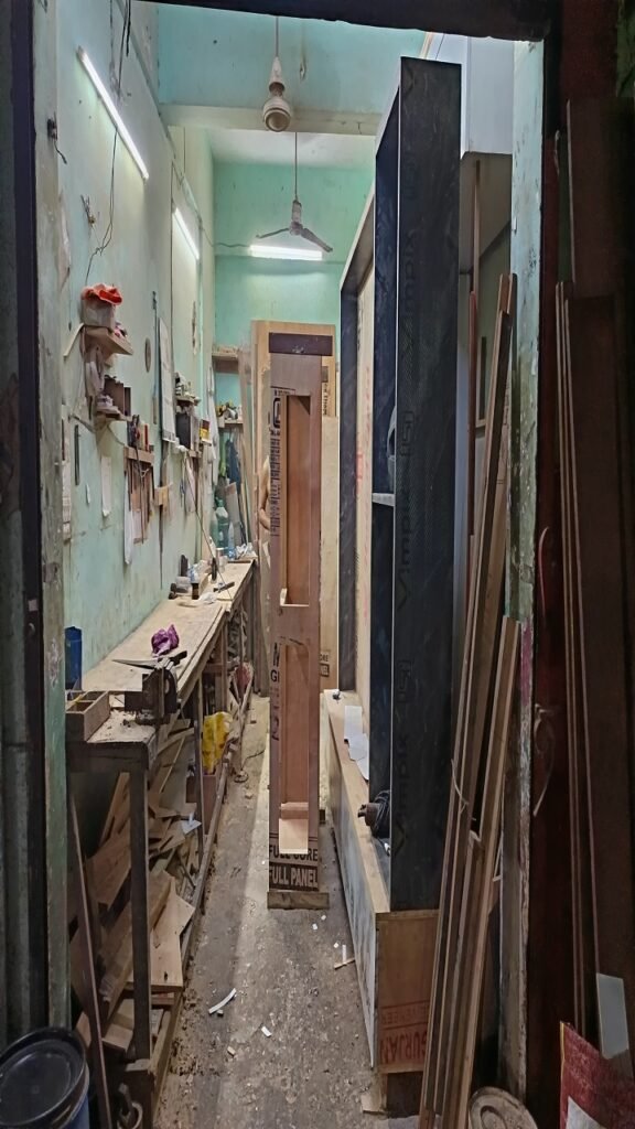 OshiClick furniture workshop interior with plywood sheets and modular cabinet manufacturing process